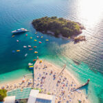 aerial-view-beautiful-white-sand-beach-with-turquoise-water-relaxing-people-sunny-day-ksamil-albania (1)